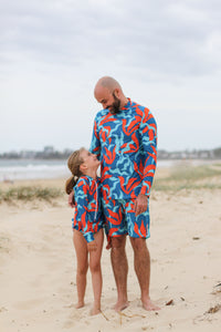 Dad and daughter in matching sunsmart swimwear.